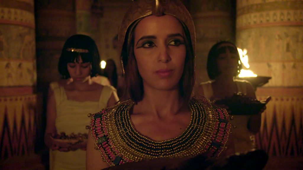 Woman in Egyptian ceremonial dress with attendants in Sacred Sites: Temple of the Priestesses