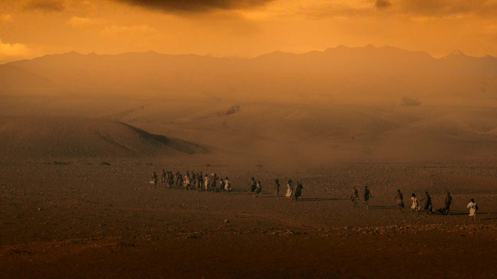 Temple worshippers crossing a desert landscape in Sacred Sites: Apocalypse